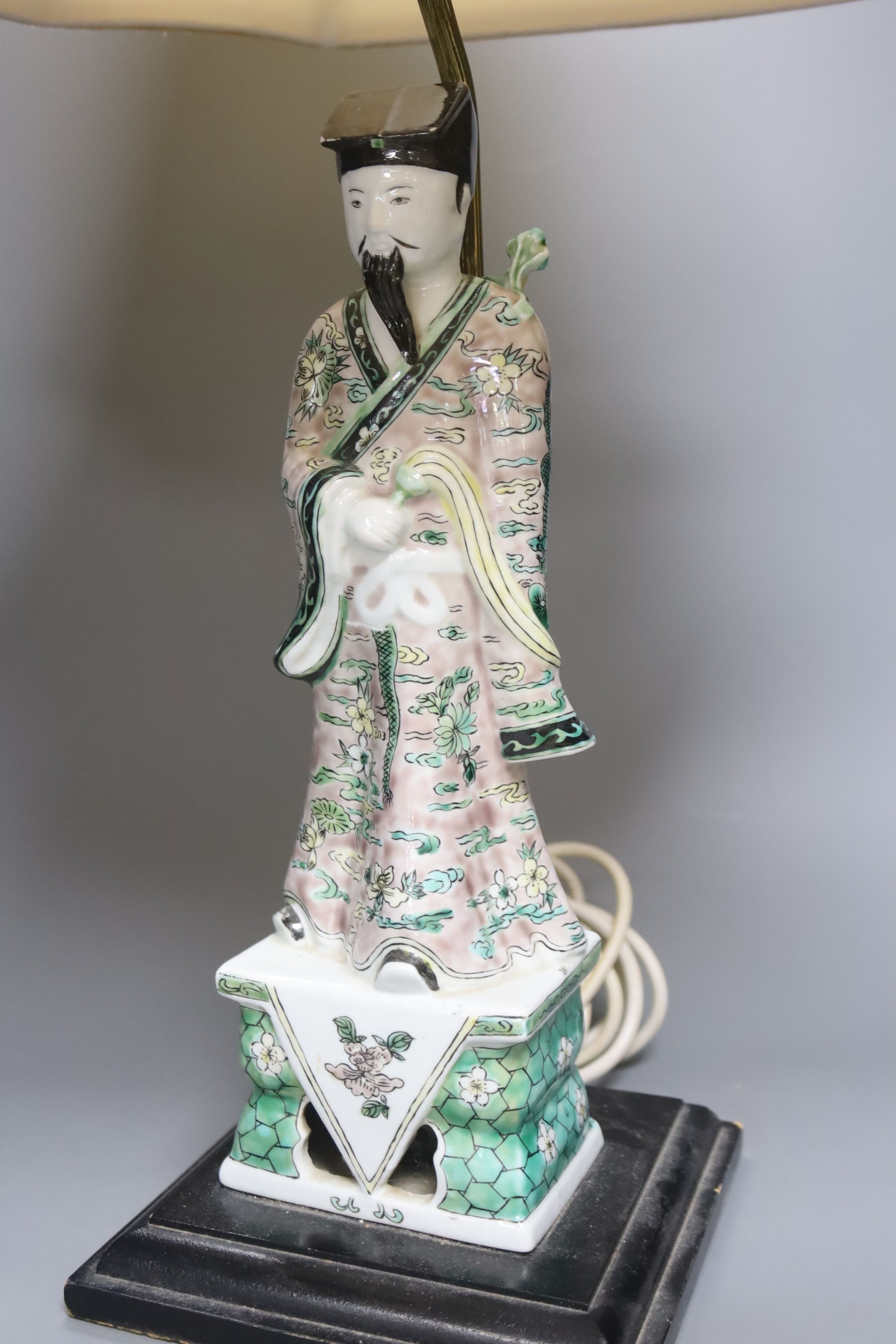 A Chinese famille verte figure of an immortal, mounted as a table lamp, height to fitting 49cm